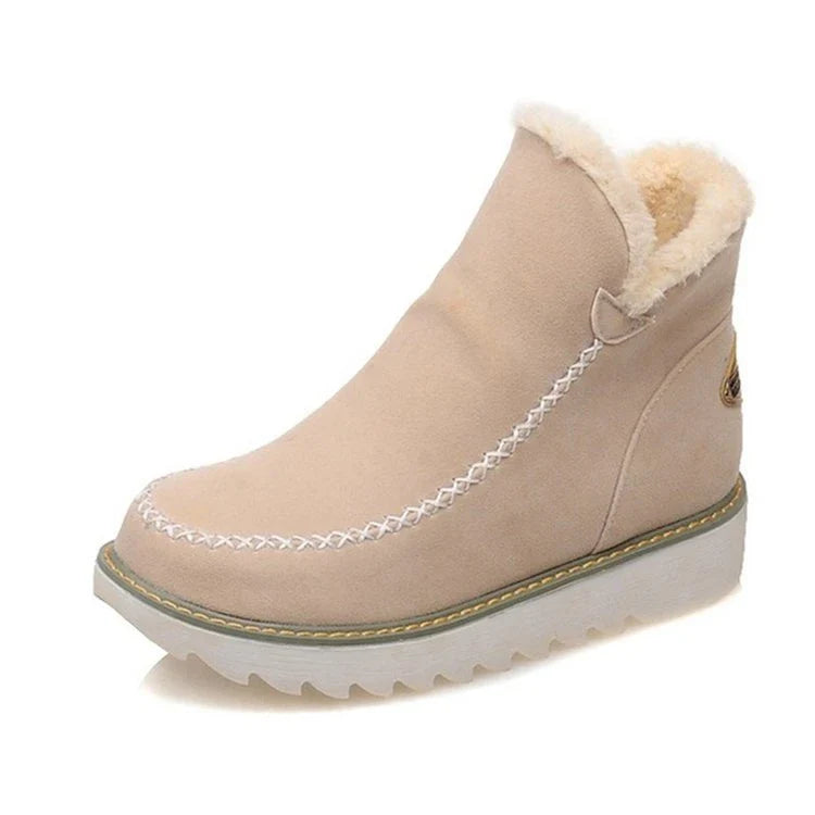 A pair of stylish, non-slip snow boots with a warm artificial wool lining, perfect for British winter weather