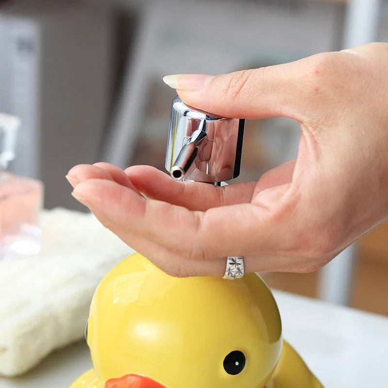 Charming yellow duck ceramic soap dispenser with matching soap dish, perfect for adding a playful touch to your bathroom or kitchen.