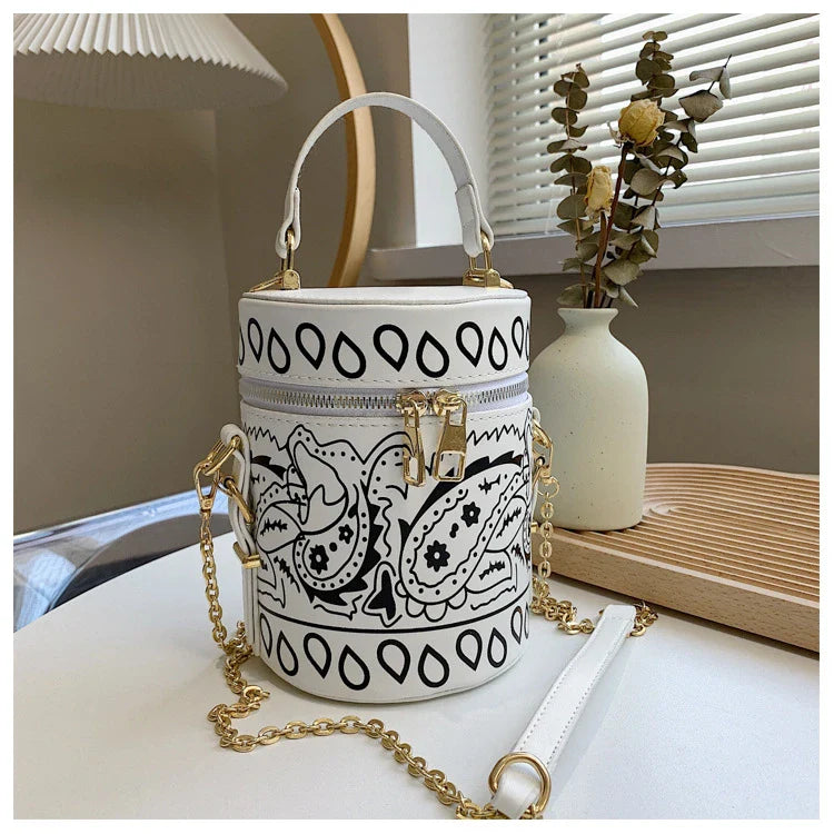 Premium PU leather bucket bag in a variety of classic and contemporary colours, featuring a spacious main compartment, adjustable shoulder strap, and sophisticated British-inspired design.