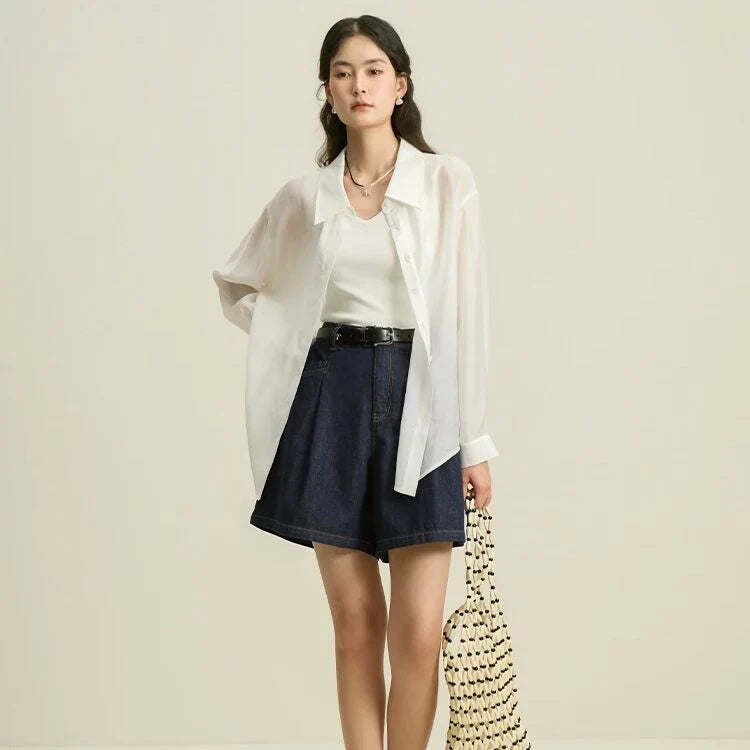 Dark denim high-waist loose shorts with retro pleated design, offering comfort and style for the modern British woman.