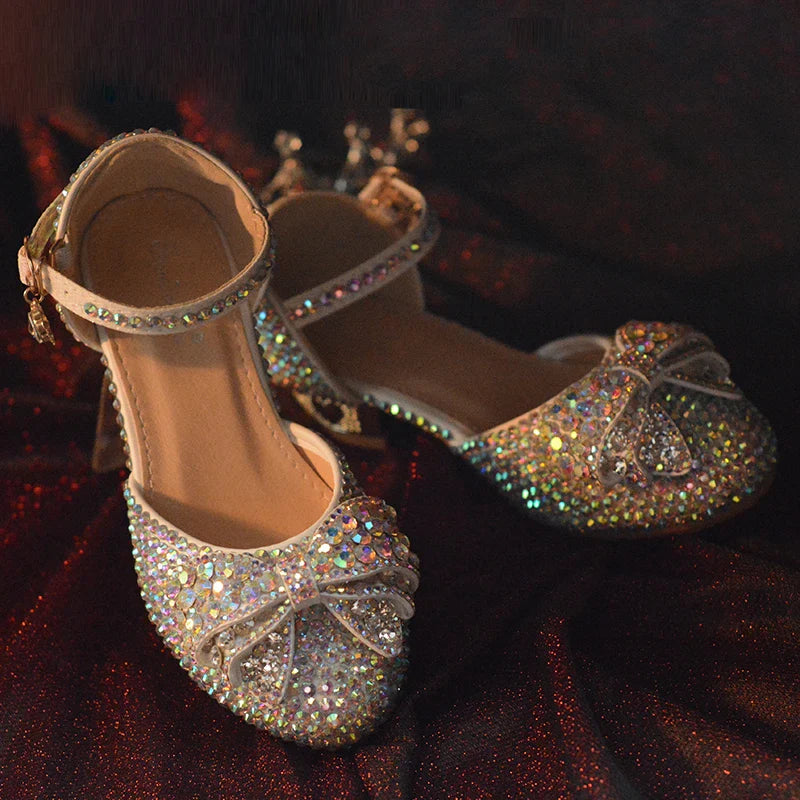 Enchanting princess crystal shoes with bow detail and dazzling crystals, perfect for girls' special occasions