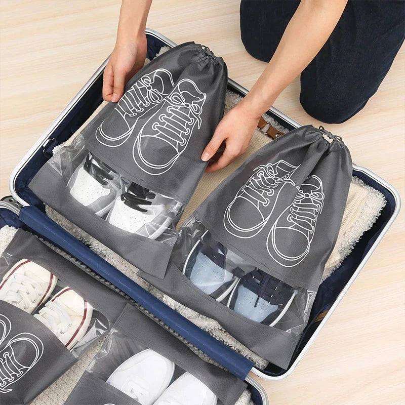 A set of grey travel shoe storage organiser bags with transparent panels for easy identification of contents