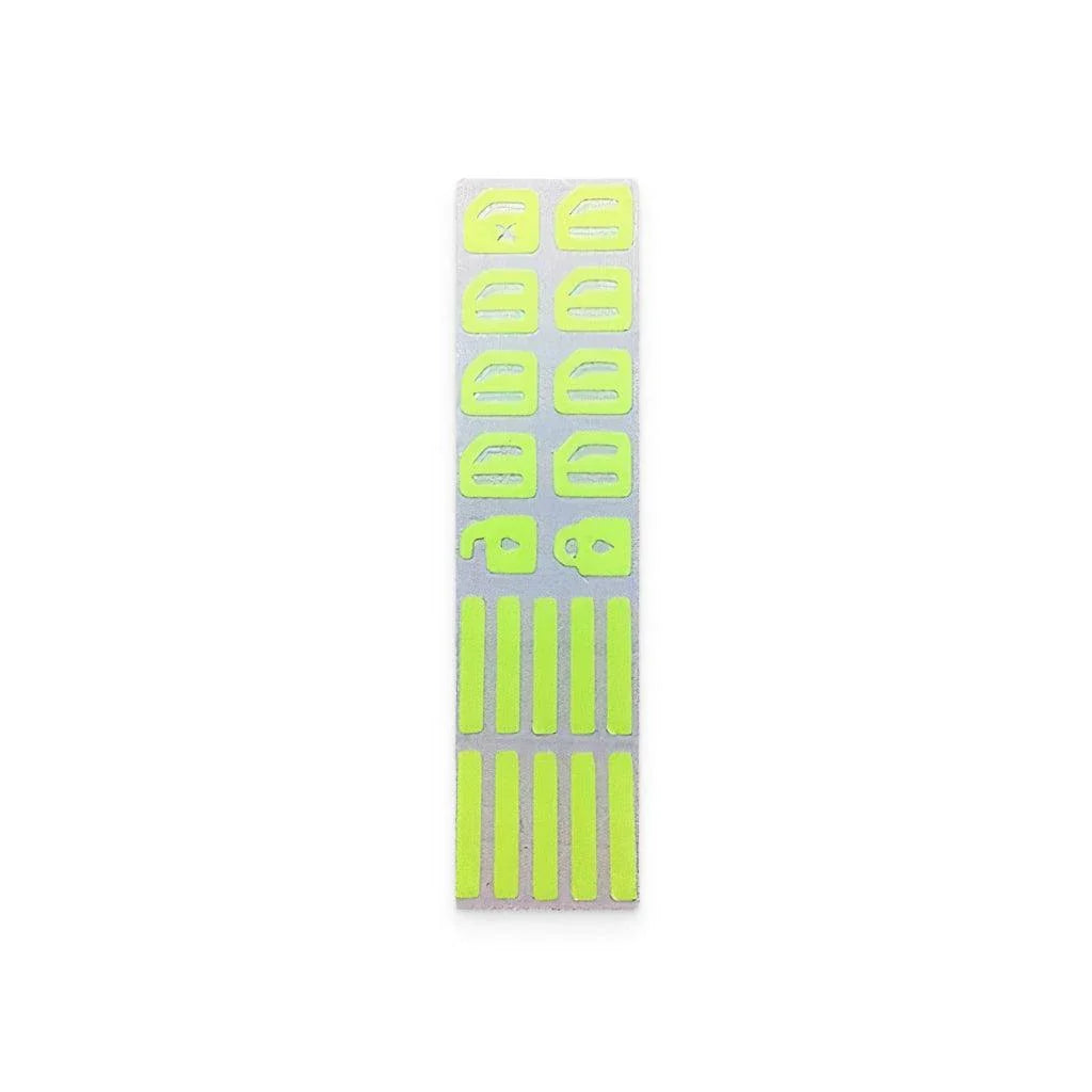 Fluorescent car button stickers emitting a bright green glow for easy visibility in the dark