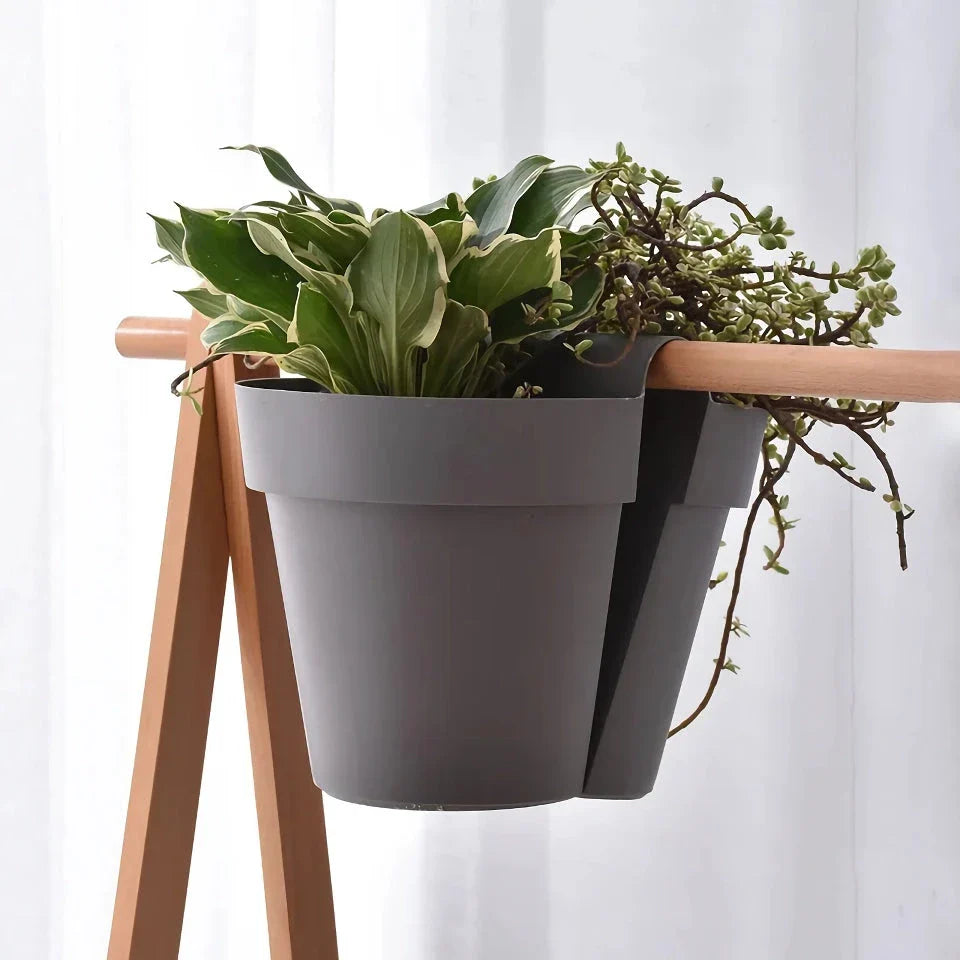 Stylish double-sided hanging rail planter in white, designed to display flowers and plants on both sides of a railing or surface