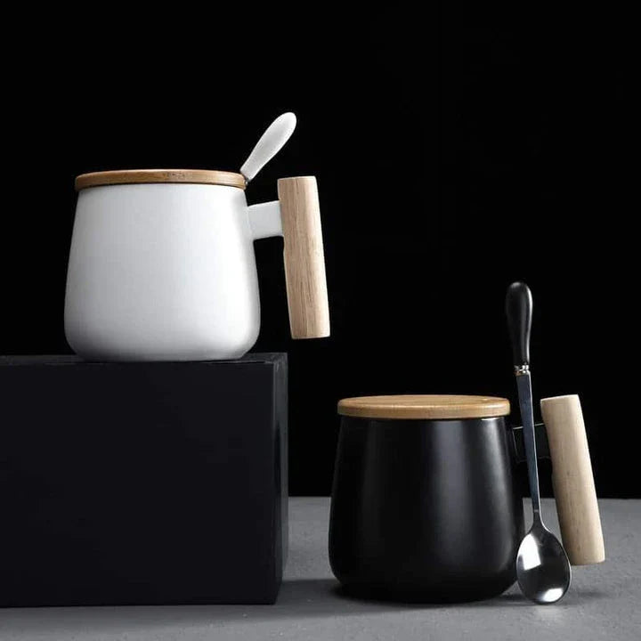A stylish ceramic coffee mug with a colour block design and a coordinating wooden spoon