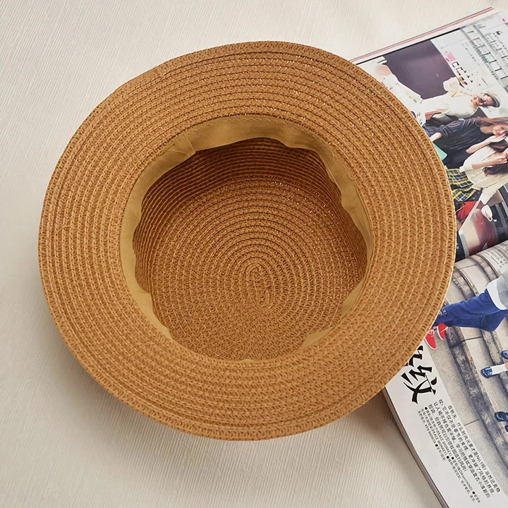 A classic summer Panama hat made from straw and paper, featuring a charming bow detail that adds a feminine touch.