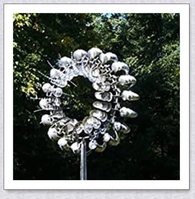 Elegant wind-powered kinetic sculpture with dual-motion blades and metallic construction, creating a mesmerizing visual display in any outdoor setting