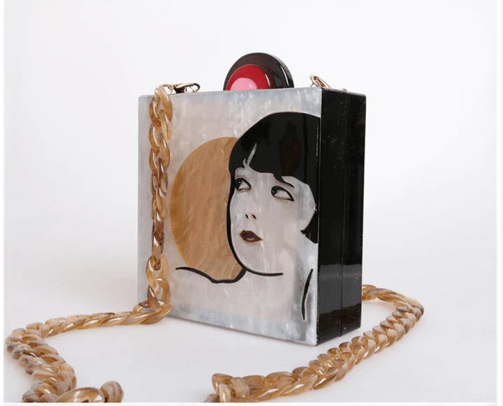 Antique hand-stitched acrylic crossbody bag in a vintage style with a yellow chain strap, perfect for evening events or everyday use.