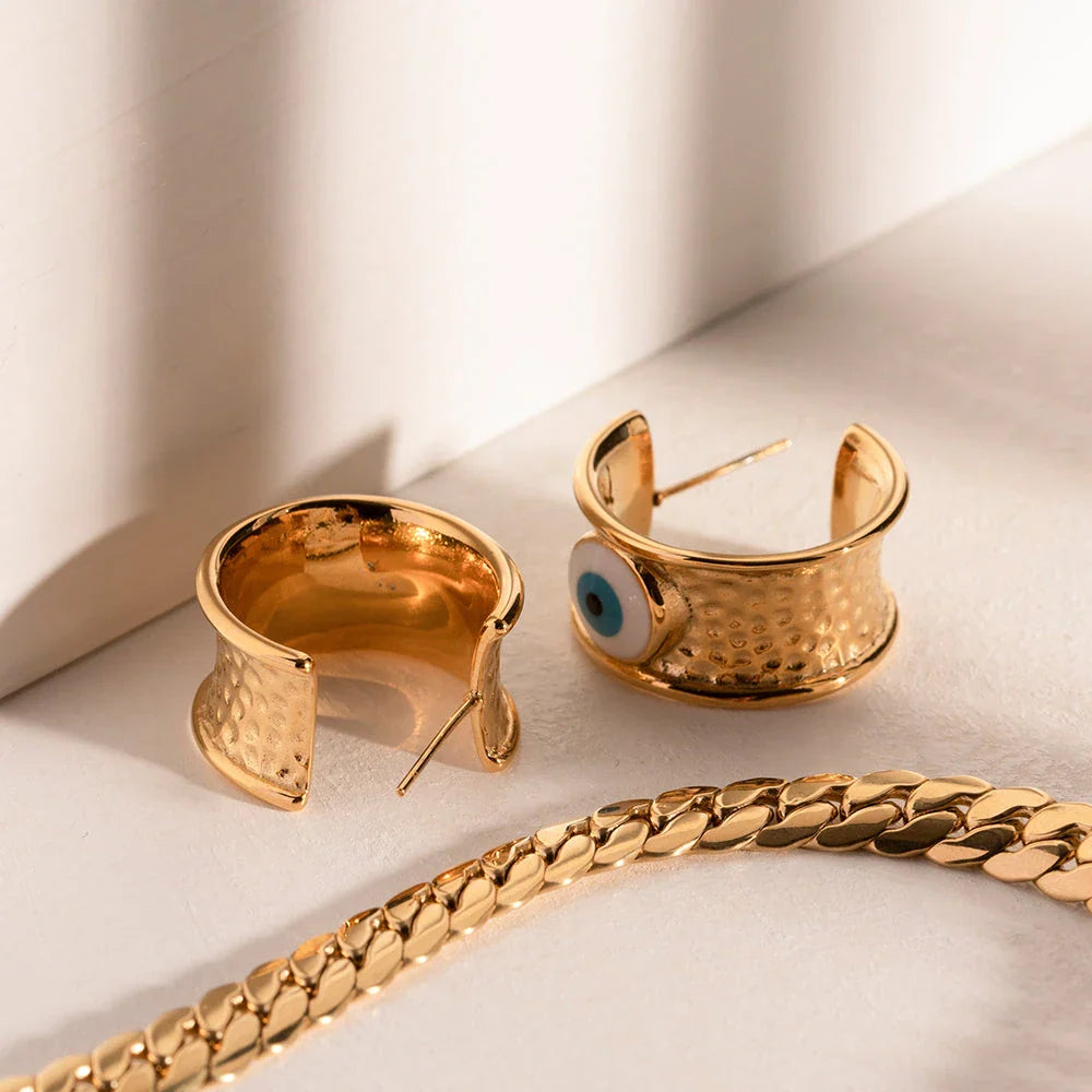 Luxury 18K gold-plated earrings with a unique Devil's Eye design and hammer grain texture in stainless steel