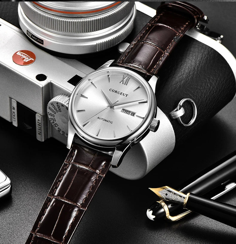 A sophisticated automatic mechanical watch with a gold/white or gold/black face, stainless steel case, and genuine leather strap
