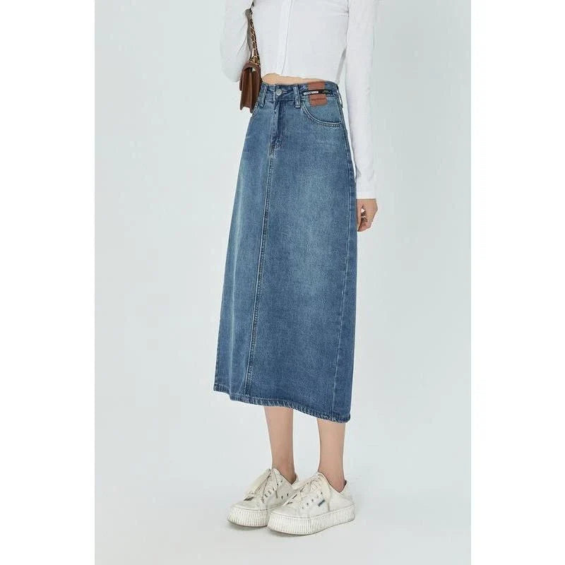Classic blue A-line midi denim skirt with flattering empire waistline and flowy silhouette