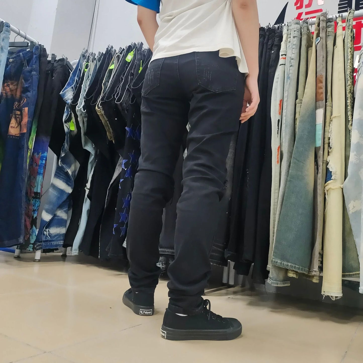 Premium ripped black jeans with stylish green patchwork design, made with medium-elastic fabric for comfort and a slim, flattering silhouette.