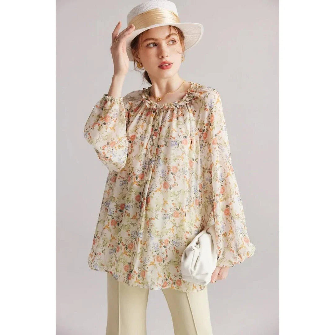 Floral silk blouse with ruffles and round neckline, showcasing the elegant and comfortable design for versatile wear.