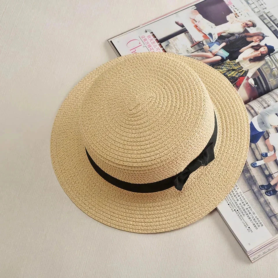 A classic summer Panama hat made from straw and paper, featuring a charming bow detail that adds a feminine touch.