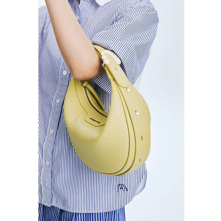 Stylish crescent-shaped leather crossbody bag with soft, supple texture for everyday elegance