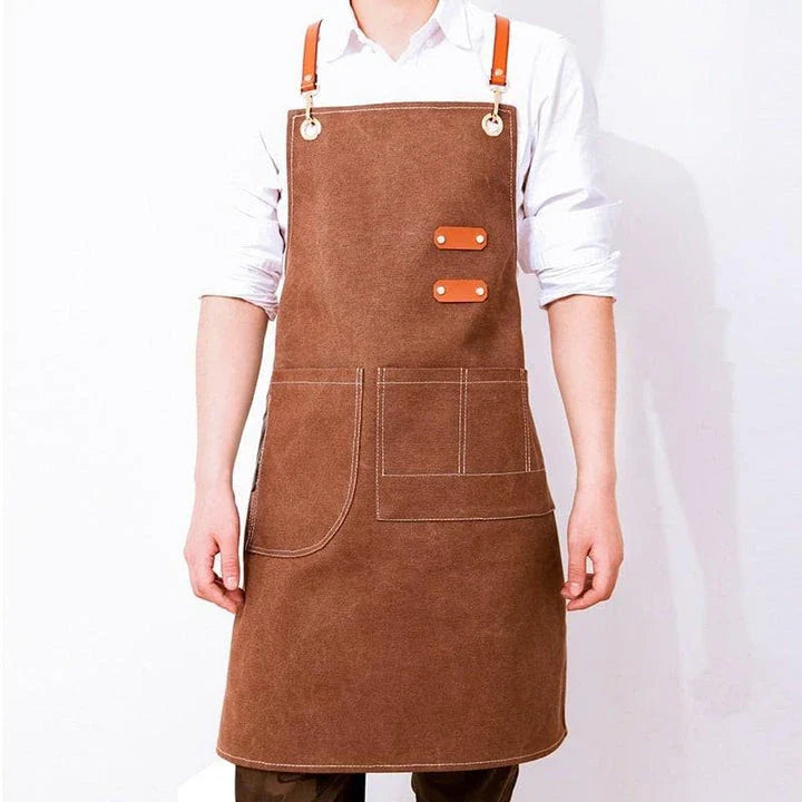 Premium canvas barista apron with British-inspired design, perfect for protecting clothing while crafting coffee.