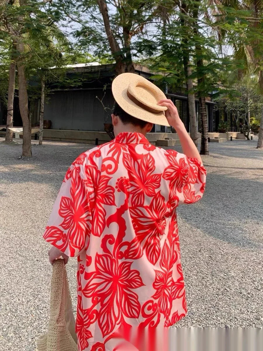 A stylish, short-sleeved shirt in a vibrant red colour with a delightful vine print pattern, perfect for casual or smart-casual occasions.