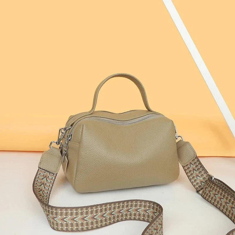 Luxurious genuine leather crossbody bag for women, featuring a soft polyester lining, dual phone pockets, and a compact, square design.