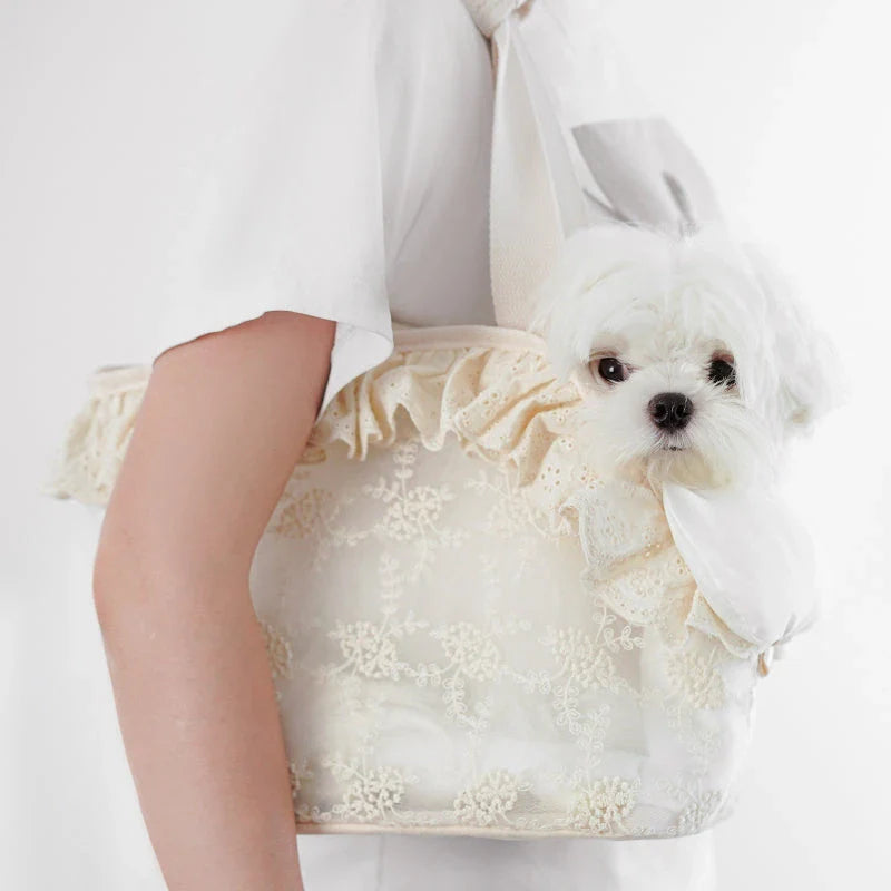 Stylish and comfortable pet carrier bag for small dogs in a floral lace design, providing breathable and cushioned support for your furry friend