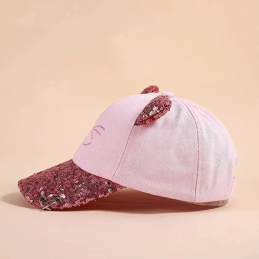 A playful, embroidered kids' baseball cap in a vibrant red panda colour, featuring a cute cartoon cat design and shimmering sequin accents.