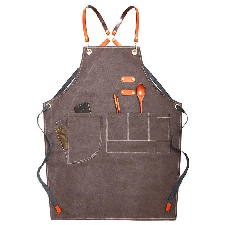 Premium canvas barista apron with British-inspired design, perfect for protecting clothing while crafting coffee.