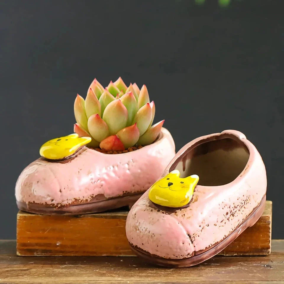 Charming ceramic boot-shaped vase with a glazed finish, perfect for displaying succulents and flowers in your home or garden
