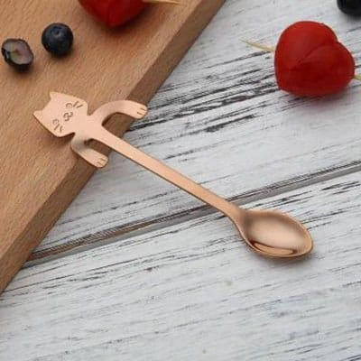 A silver cat-shaped stainless steel coffee spoon with a polished finish