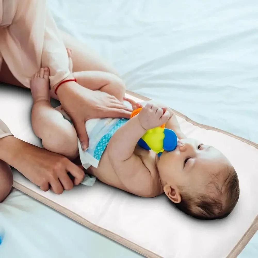 Premium waterproof changing pad for babies, featuring a compact, foldable design and soft, skin-friendly materials for a comfortable, hygienic nappy changing experience on the go.