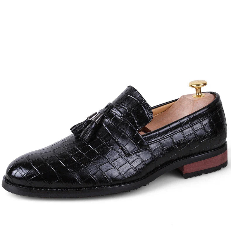 Premium British-crafted men's pointed leather dress shoes with tassels in black color