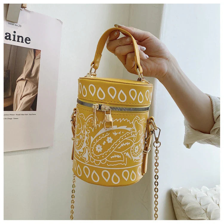 Premium PU leather bucket bag in a variety of classic and contemporary colours, featuring a spacious main compartment, adjustable shoulder strap, and sophisticated British-inspired design.
