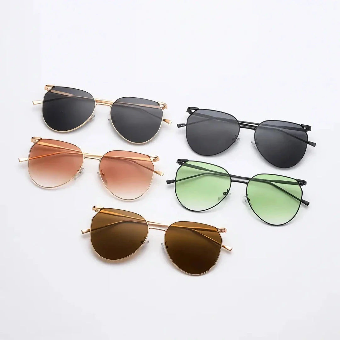Elegant oval-shaped sunglasses with gradient lenses and alloy frames, offering timeless British style and UV protection.