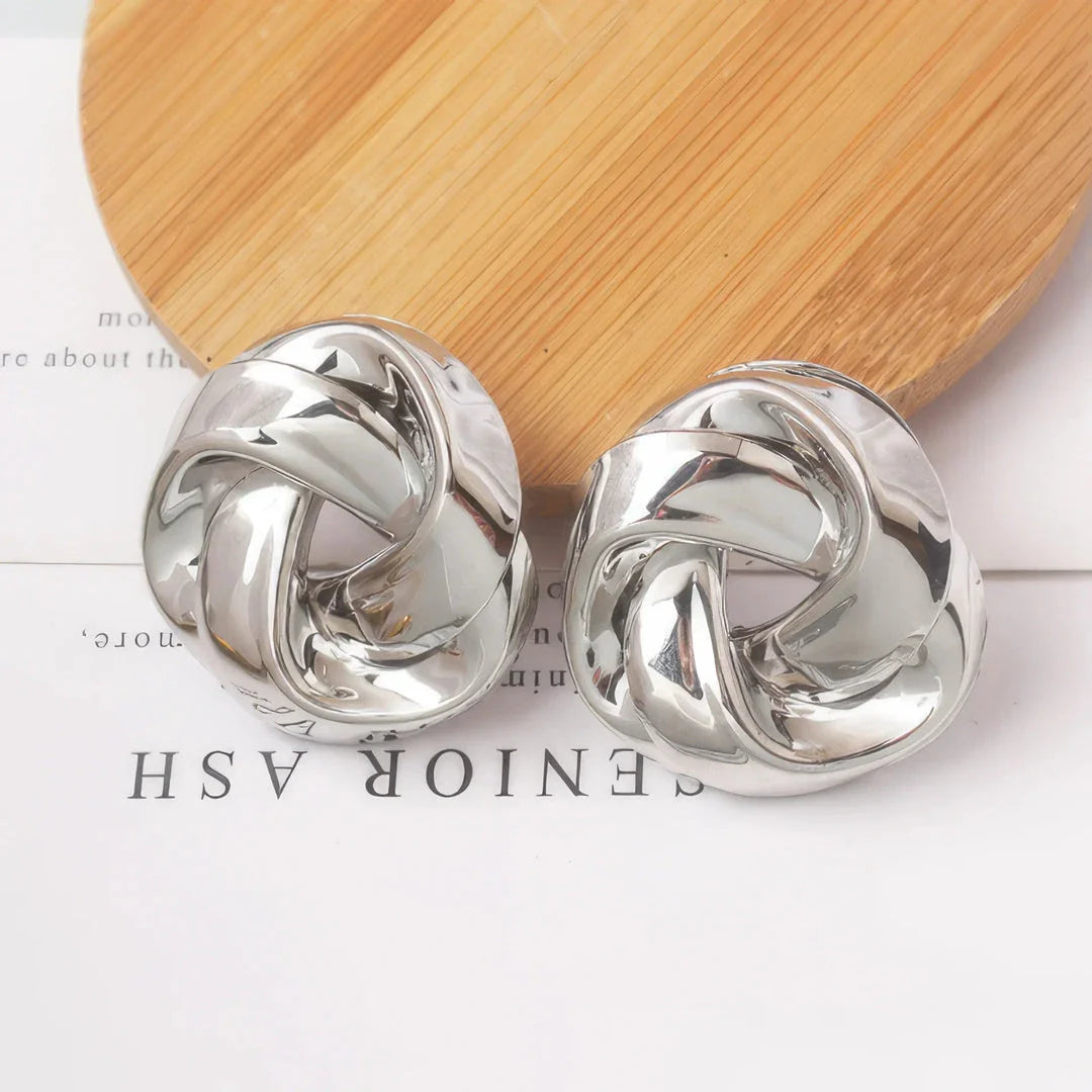 Pair of gold spiral drop earrings with an exaggerated, dramatic design for a bold, fashionable look