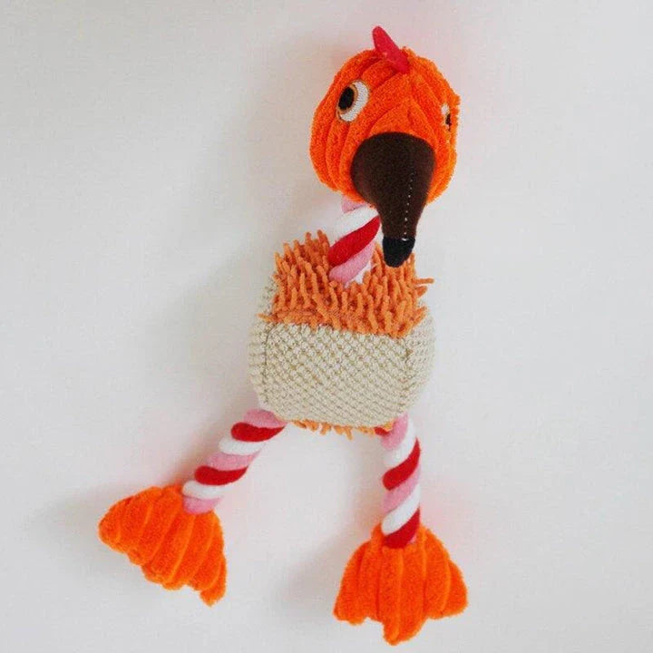 A plush, bird-shaped dog toy in a pink colour. It is designed to encourage chewing and snuggling behaviour in dogs.