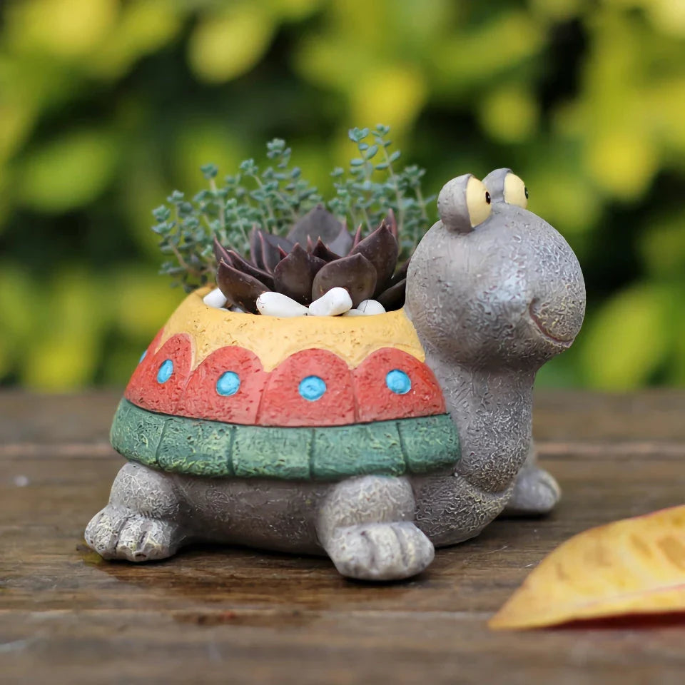 A charming, hand-painted resin planter in the shape of a cartoon turtle, perfect for displaying succulents, cacti, and other small plants.