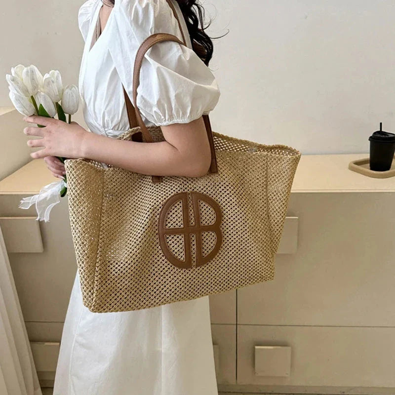 A handmade straw tote bag with a unique hollow-out knitting design, featuring a soft faux fur lining and a spacious interior for versatile use.