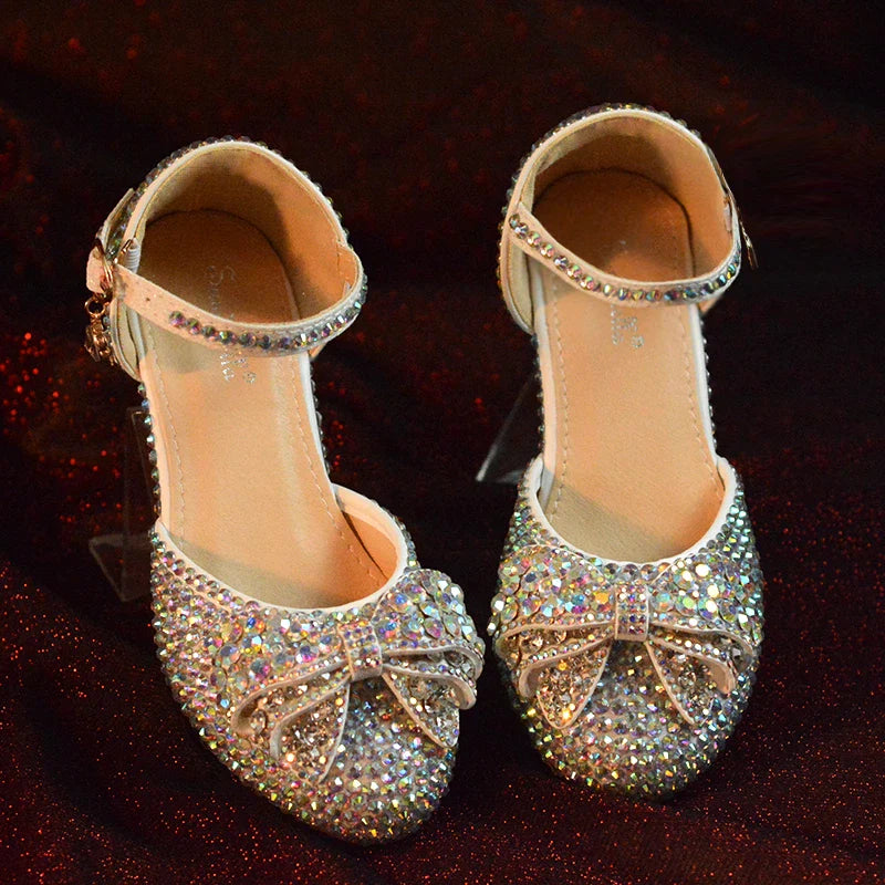Enchanting princess crystal shoes with bow detail and dazzling crystals, perfect for girls' special occasions