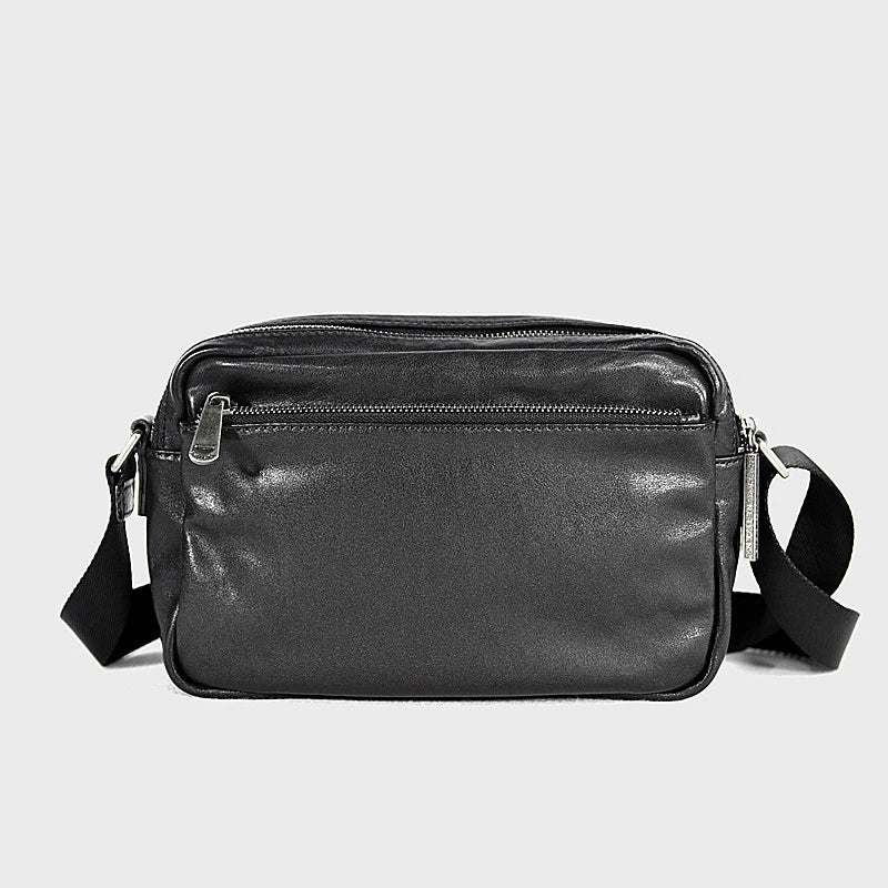 A premium British leather shoulder bag with a sleek, minimalist design and adjustable strap