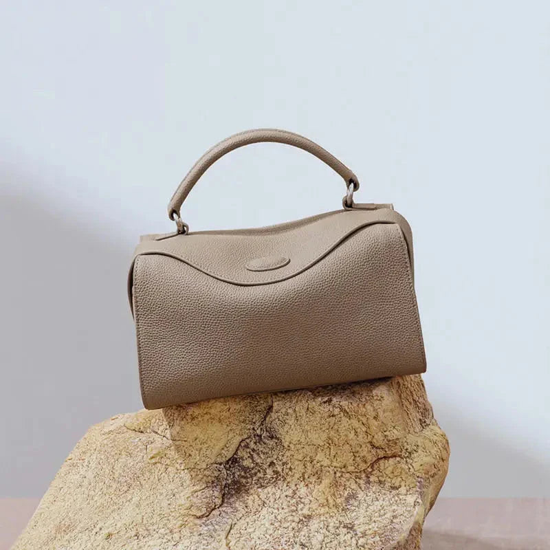 Premium British cowhide leather shoulder bag with multiple interior pockets and adjustable strap for versatile wear