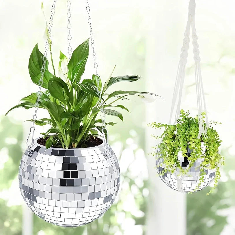 A sparkling silver disco ball hanging planter with reflective glass mirrors, adding a modern and stylish touch to any indoor or outdoor space.