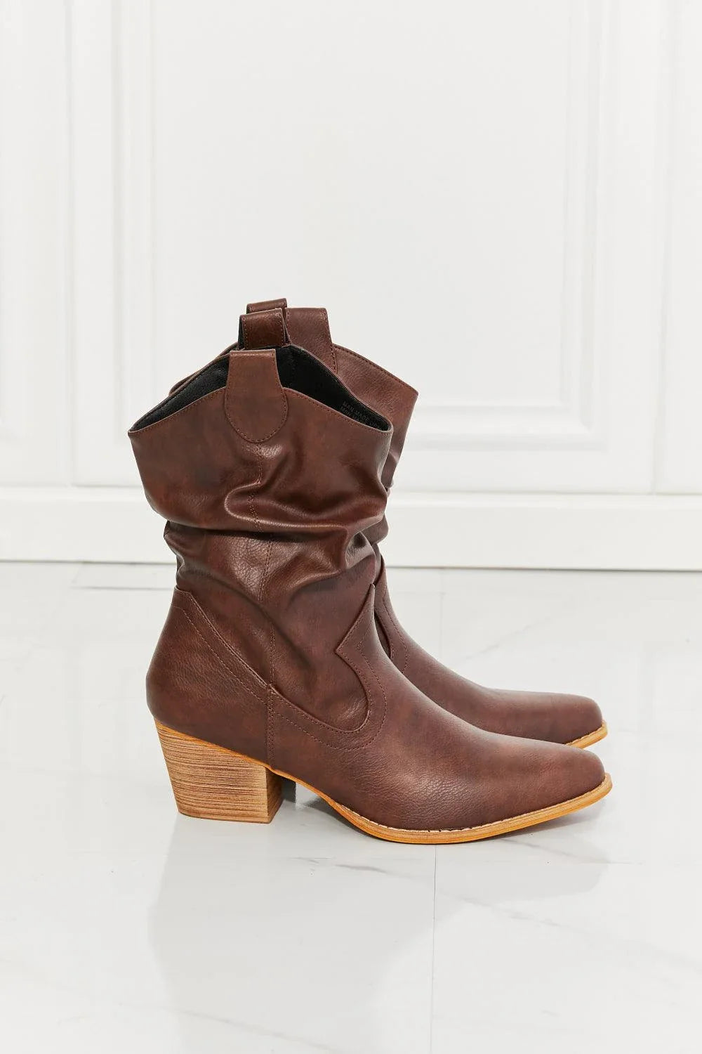 Stylish scrunch cowboy boots in a rich brown colour, perfect for pairing with jeans or dresses for a touch of rustic charm.