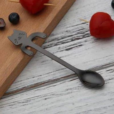 A silver cat-shaped stainless steel coffee spoon with a polished finish