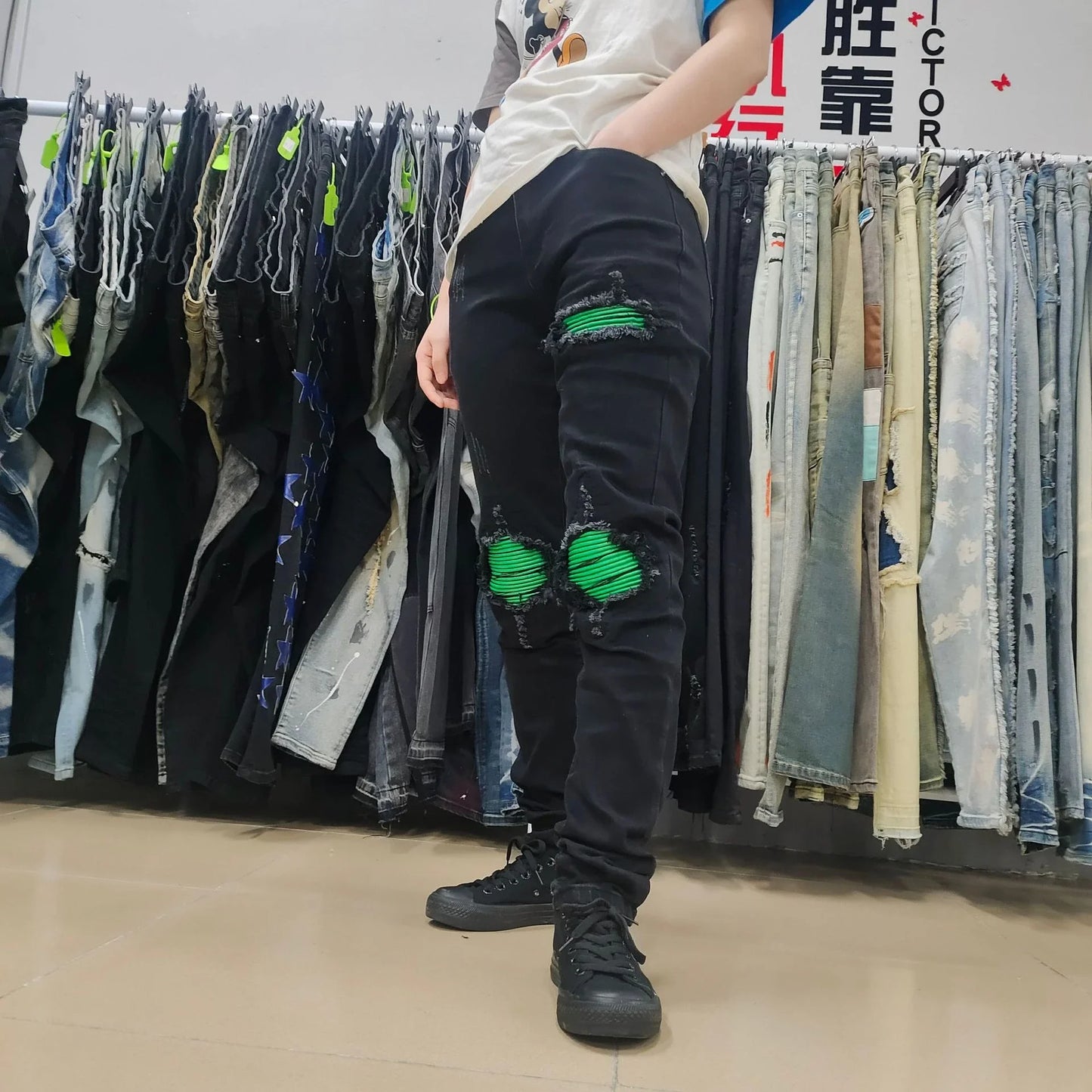 Premium ripped black jeans with stylish green patchwork design, made with medium-elastic fabric for comfort and a slim, flattering silhouette.