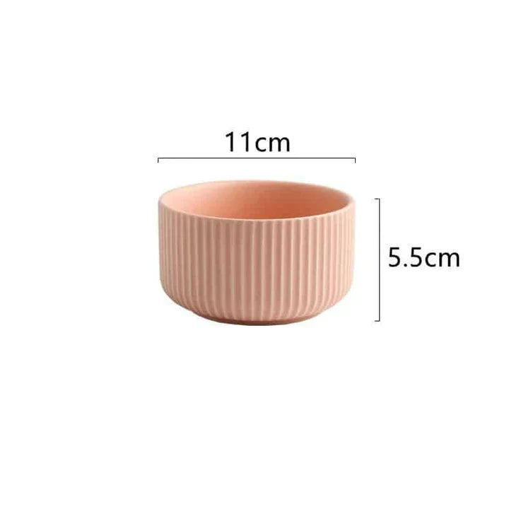 Candy-coloured ribbed ceramic tableware featuring plates, bowls, and other dining accessories in vibrant hues