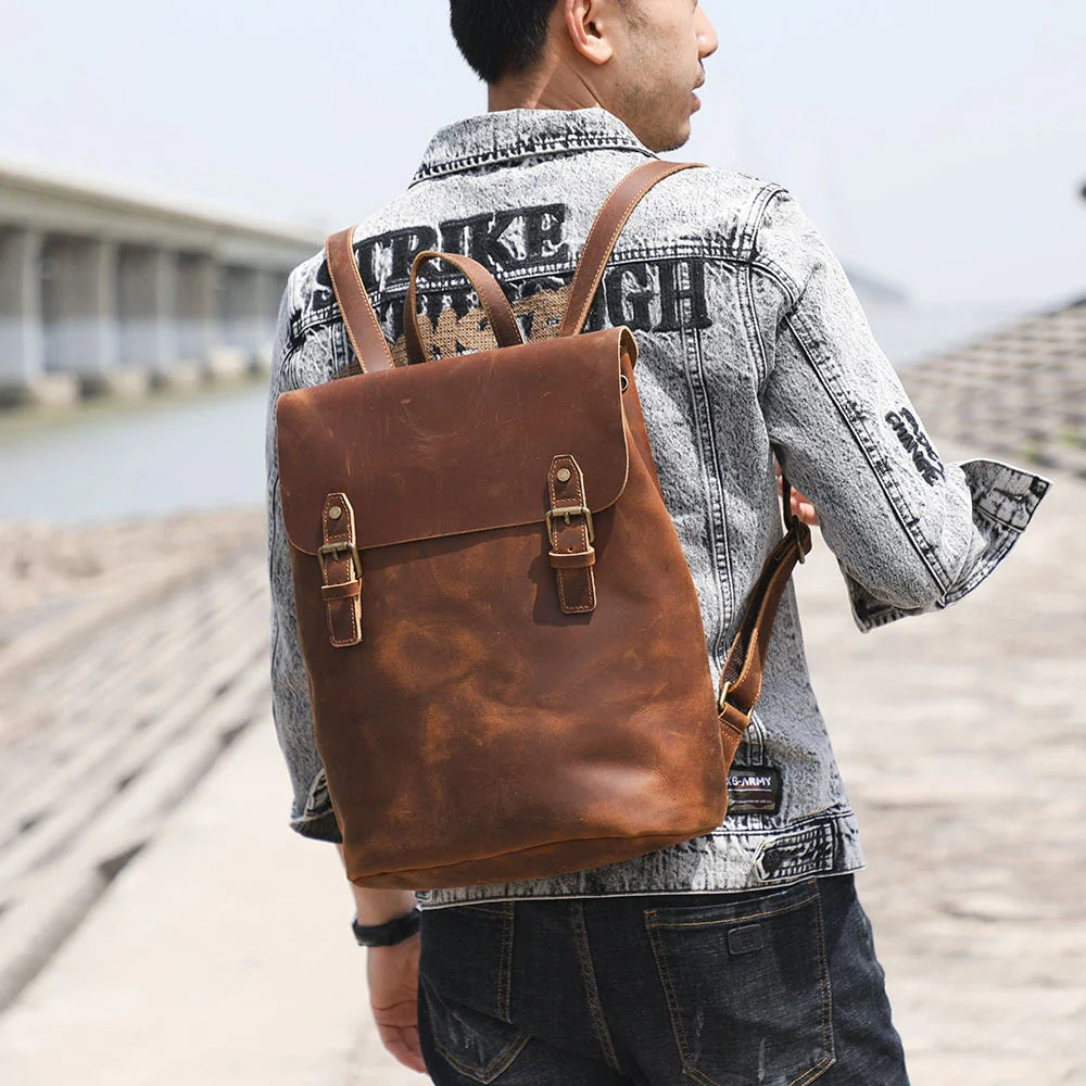 Premium vintage leather backpack with a classic design, featuring a spacious main compartment and adjustable padded shoulder straps for comfortable wear.