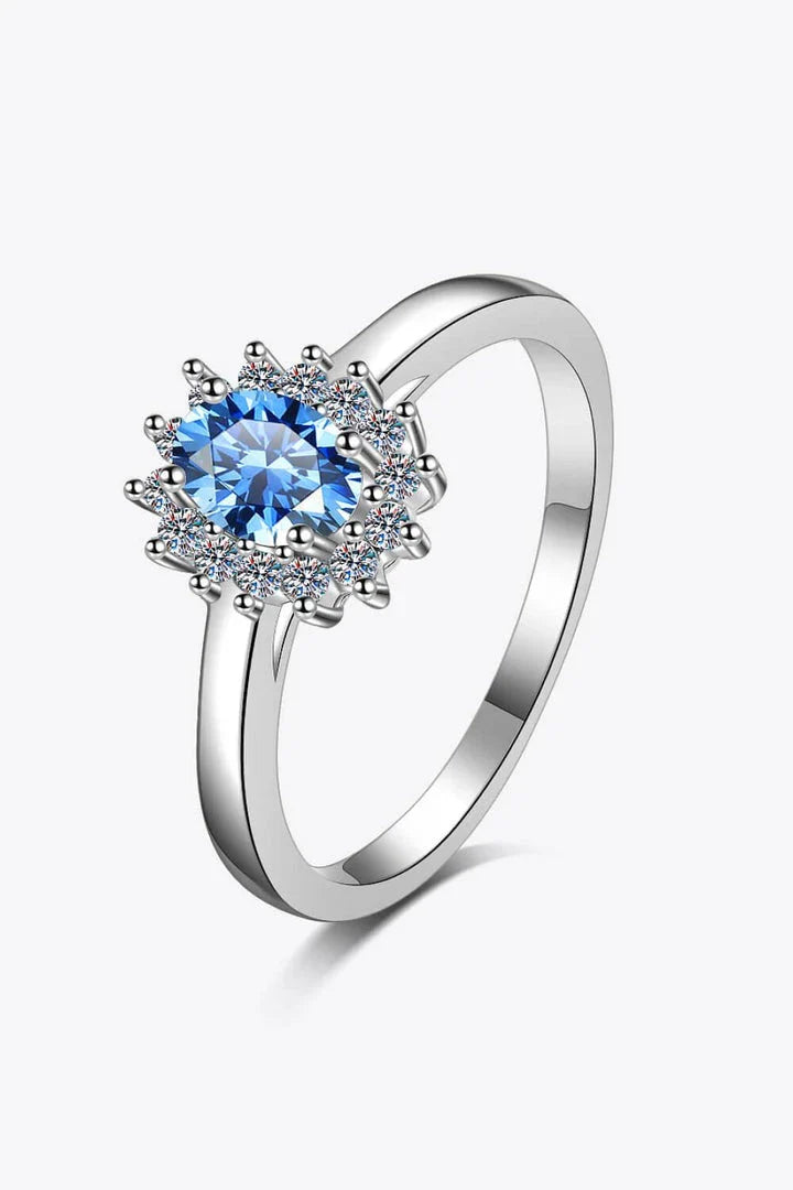 A close-up of a minimalist, polished 925 sterling silver ring with a dazzling moissanite centre stone