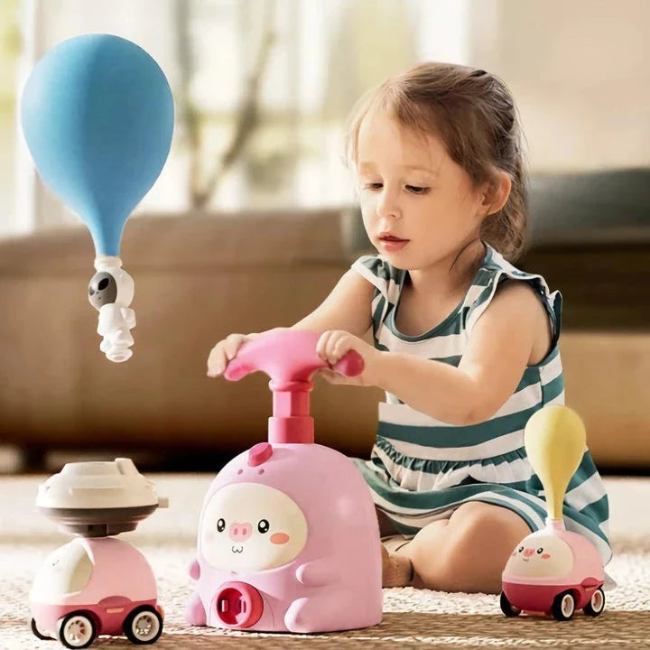 Balloon-powered launcher and car set for children, featuring a pink pig design and components for educational science play