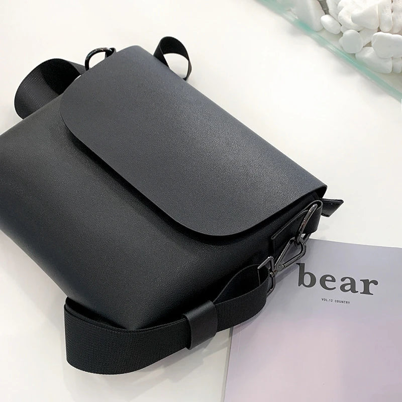 Black PU leather messenger bag with adjustable strap and zippered pockets, a stylish and practical accessory for British gentlemen