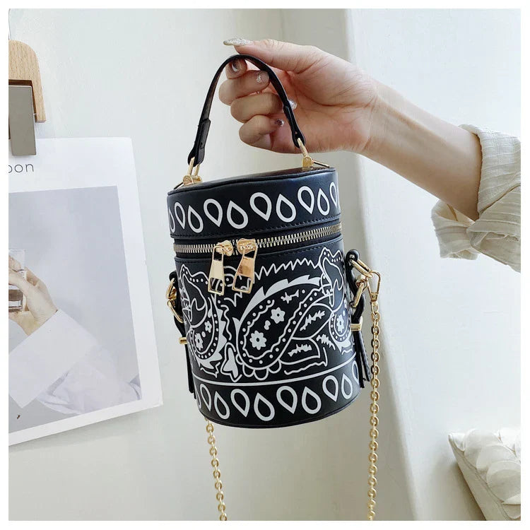 Premium PU leather bucket bag in a variety of classic and contemporary colours, featuring a spacious main compartment, adjustable shoulder strap, and sophisticated British-inspired design.