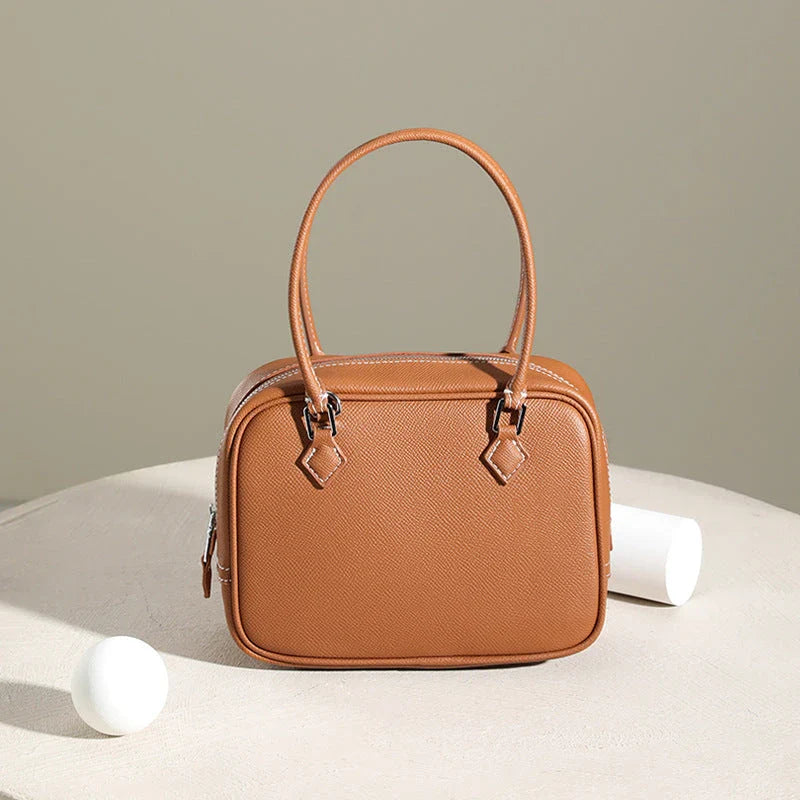 Elegant leather mini shoulder bag in a variety of colours, featuring a compact and versatile design for the stylish British woman.