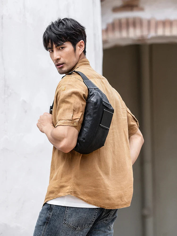 Premium cowhide messenger bag in black, featuring a spacious interior, adjustable shoulder strap, and sleek, minimalist design